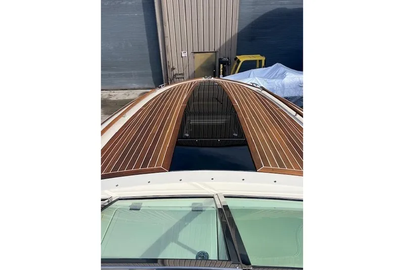  Yacht Photos Pics 2017 Chris-Craft Corsair 32 with sleek wooden deck design in a marina setting.