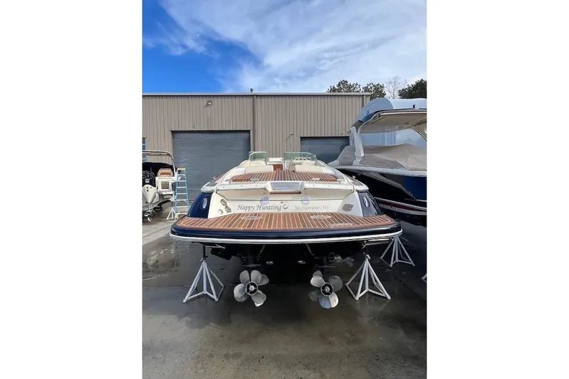  Yacht Photos Pics 2017 Chris-Craft Corsair 32 boat in storage, showcasing dual propellers and wooden deck.