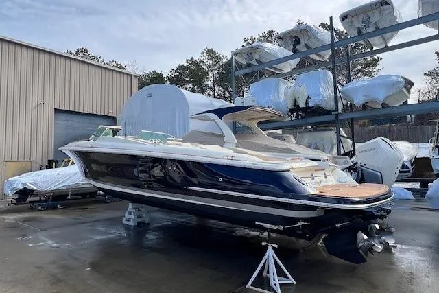  Yacht Photos Pics 2017 Chris-Craft Corsair 32 boat in storage, surrounded by other covered vessels.