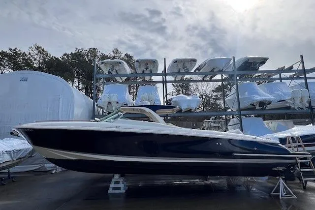  Yacht Photos Pics 2017 Chris-Craft Corsair 32 boat in storage, surrounded by other vessels.