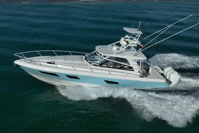 Rising Tide Yacht Photos Pics 2023 Intrepid 477 Evolution yacht cruising on open water, showcasing sleek design and powerful engines.