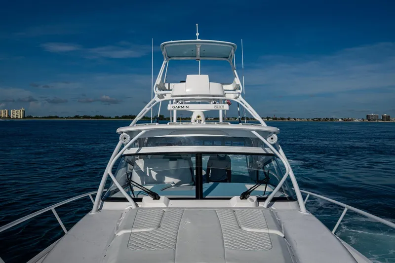 Rising Tide Yacht Photos Pics 2023 Intrepid 477 Evolution yacht cruising on open water under clear blue skies.