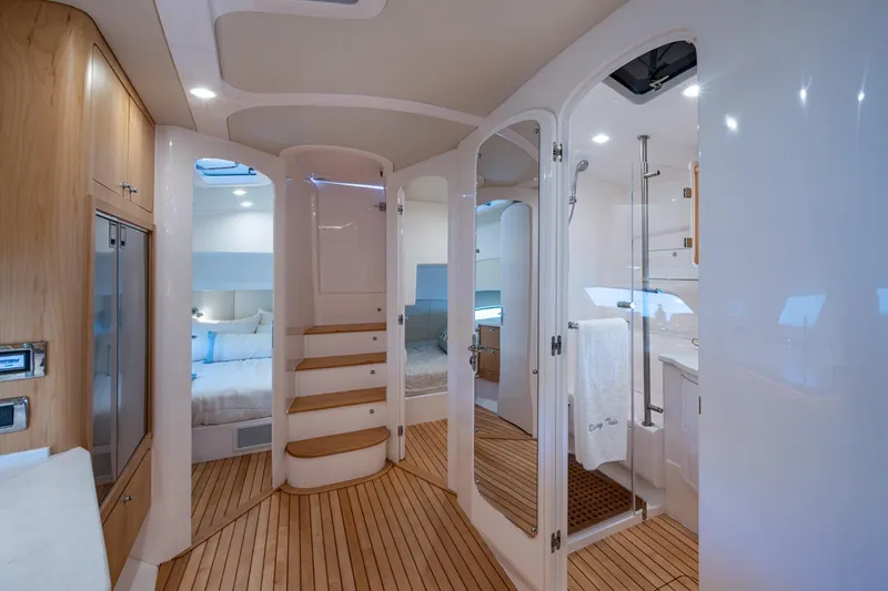 Rising Tide Yacht Photos Pics Luxurious interior of 2023 Intrepid 477 Evolution yacht with modern design and wooden flooring.