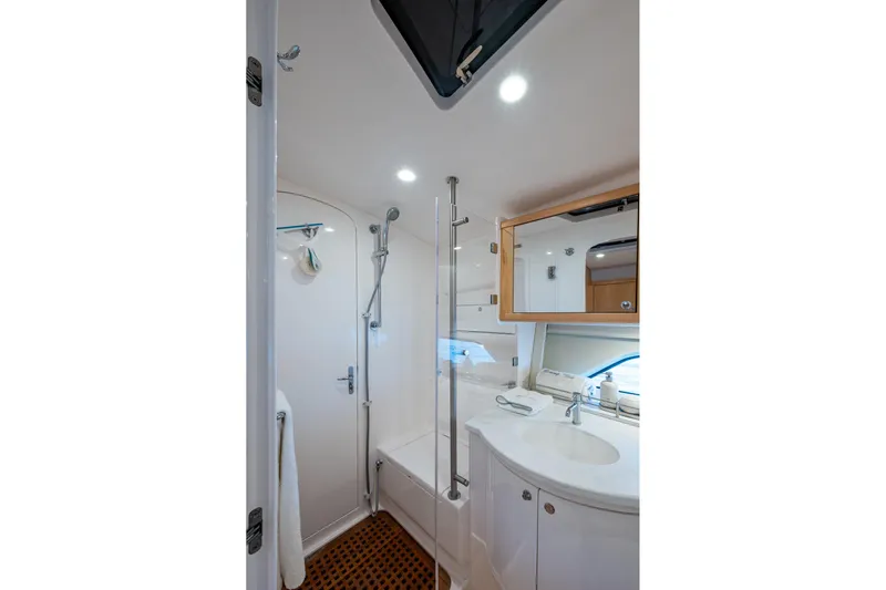 Rising Tide Yacht Photos Pics Modern bathroom interior of 2023 Intrepid 477 Evolution yacht, featuring shower and vanity.