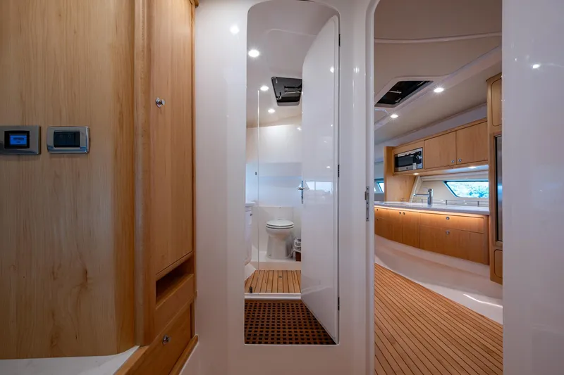 Rising Tide Yacht Photos Pics Luxurious interior of 2023 Intrepid 477 Evolution yacht, featuring modern kitchen and bathroom.