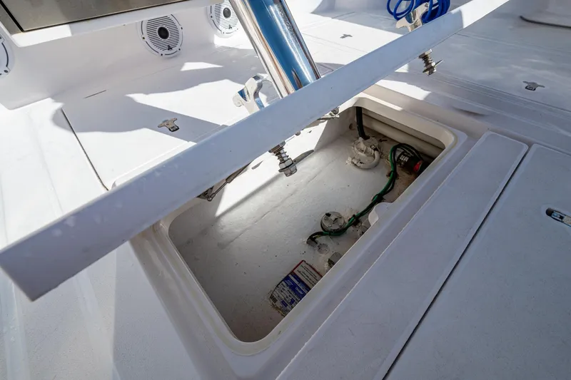 Rising Tide Yacht Photos Pics 2023 Intrepid 477 Evolution boat storage compartment with open hatch and visible wiring.