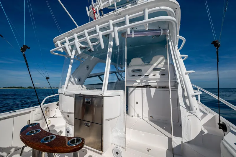 Rising Tide Yacht Photos Pics 2023 Intrepid 477 Evolution boat cockpit with fishing rods and ocean view.