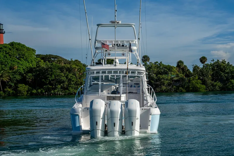 Rising Tide Yacht Photos Pics 2023 Intrepid 477 Evolution boat with triple engines on a scenic waterway.