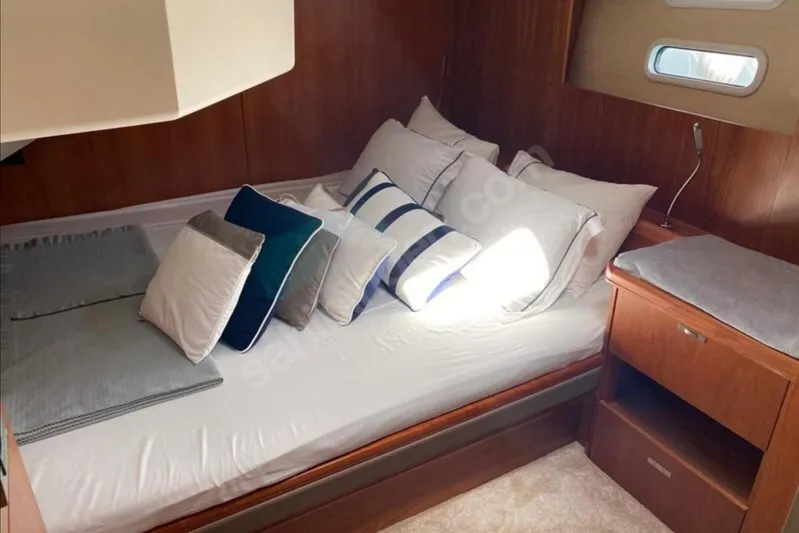 Moody Ds 54 Yacht Photos Pics Cozy cabin interior of 2019 Moody DS 54 yacht with plush bedding and wooden furnishings.