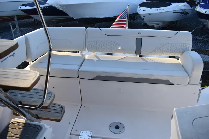  Yacht Photos Pics 2025 Regal 38 FXO boat seating area with American flag, showcasing luxury design.