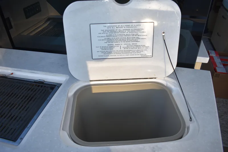  Yacht Photos Pics Open hatch on 2025 Regal 38 FXO boat with waste disposal instructions.