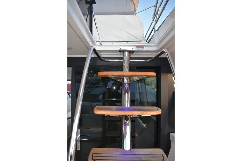  Yacht Photos Pics Stainless steel and wood staircase on 2025 Regal 38 FXO yacht.