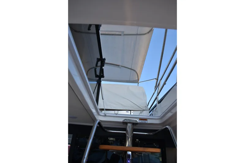  Yacht Photos Pics 2025 Regal 38 FXO yacht interior view with open sunroof and railing.