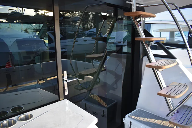  Yacht Photos Pics 2025 Regal 38 FXO yacht interior with modern staircase and sleek design elements.