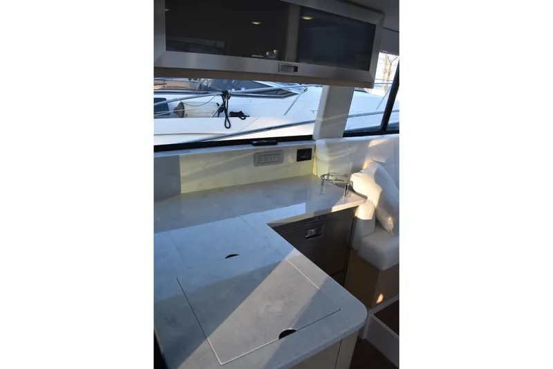  Yacht Photos Pics Modern kitchen area on 2025 Regal 38 FXO yacht with sleek countertops and appliances.