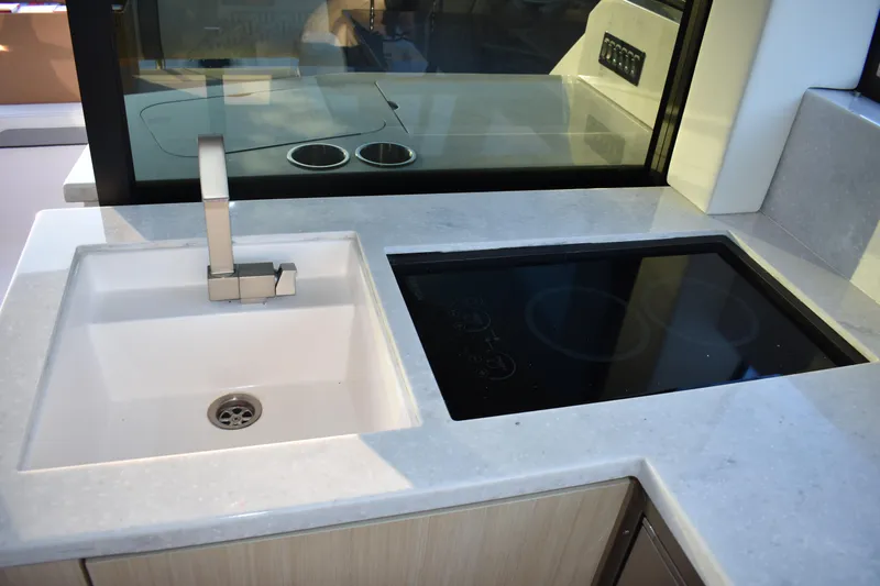  Yacht Photos Pics Modern kitchen area in 2025 Regal 38 FXO yacht with sink and stovetop.