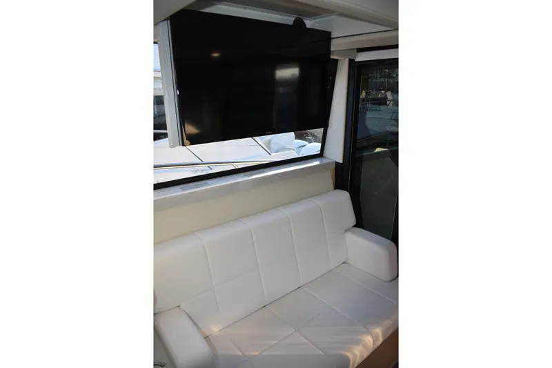  Yacht Photos Pics Interior of 2025 Regal 38 FXO yacht with white seating and mounted TV.