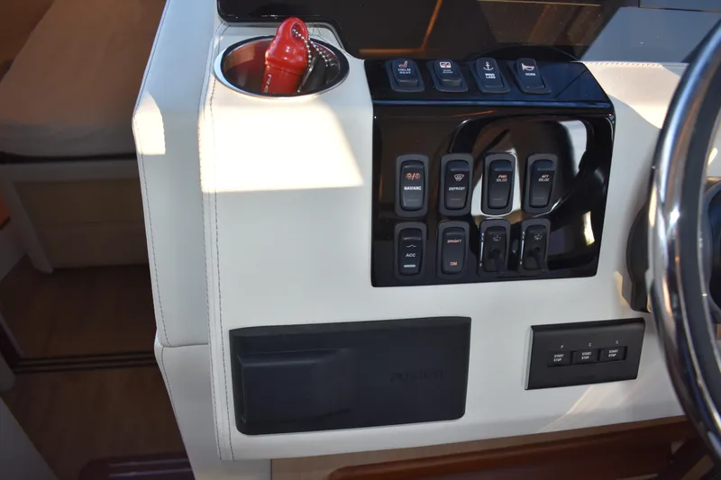  Yacht Photos Pics Control panel of 2025 Regal 38 FXO boat with switches and cup holder.