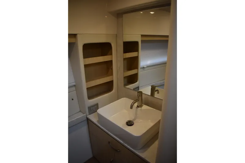  Yacht Photos Pics Modern bathroom sink in 2025 Regal 38 FXO yacht, featuring sleek design and storage shelves.