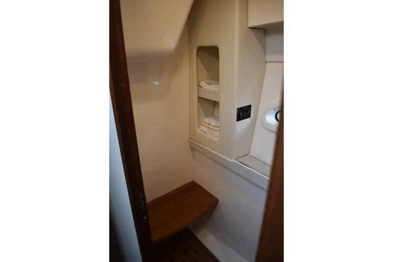  Yacht Photos Pics Interior of 2025 Regal 38 FXO boat, featuring compact storage and seating area.