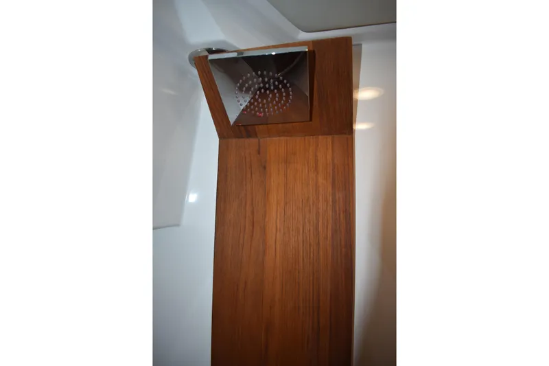  Yacht Photos Pics Shower area in 2025 Regal 38 FXO boat with wooden paneling.