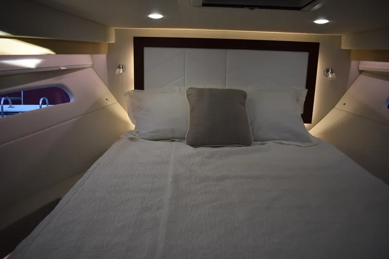  Yacht Photos Pics Luxurious cabin interior of 2025 Regal 38 FXO yacht with cozy bedding.