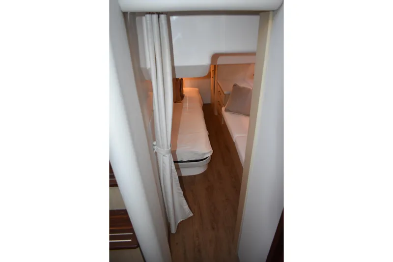 Yacht Photos Pics Interior cabin of 2025 Regal 38 FXO yacht with cozy beds and warm lighting.