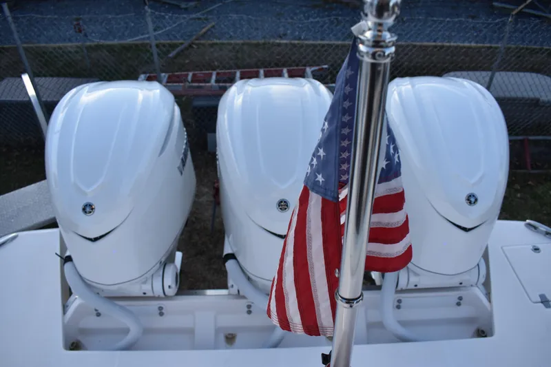  Yacht Photos Pics Triple outboard engines on 2025 Regal 38 FXO boat with American flag.