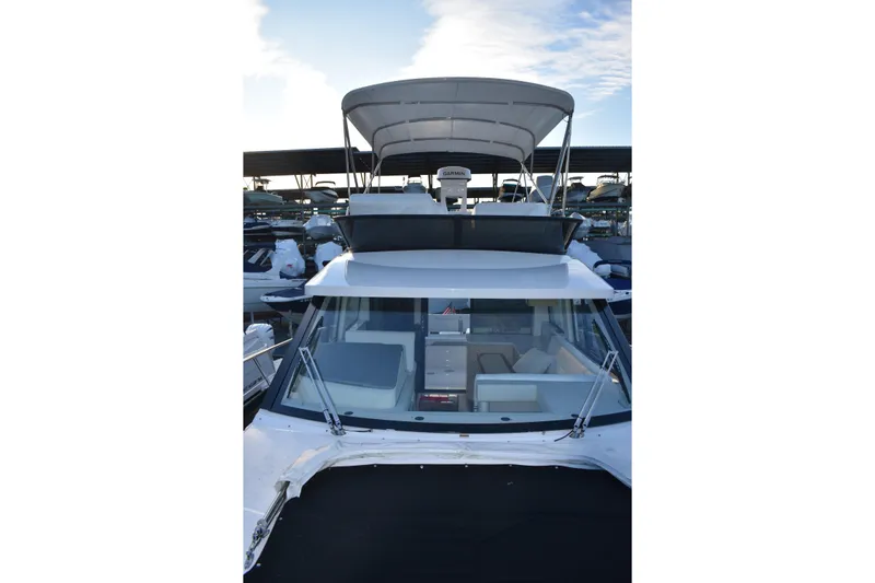  Yacht Photos Pics 2025 Regal 38 FXO yacht with flybridge, docked in marina.