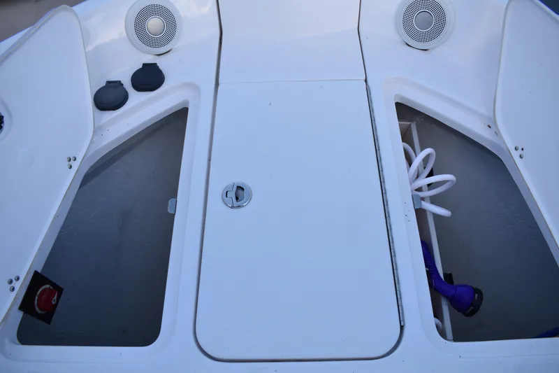  Yacht Photos Pics 2025 Regal 38 FXO boat storage compartments with speakers and hose.