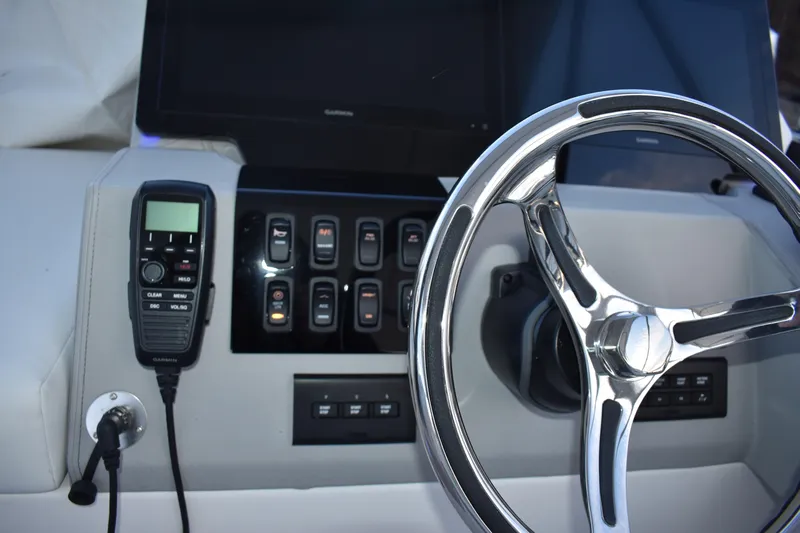  Yacht Photos Pics Helm of 2025 Regal 38 FXO boat with steering wheel and control panel.