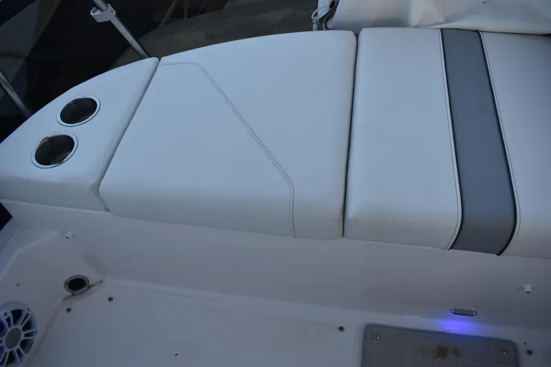  Yacht Photos Pics 2025 Regal 38 FXO boat seating area with cup holders and speaker.