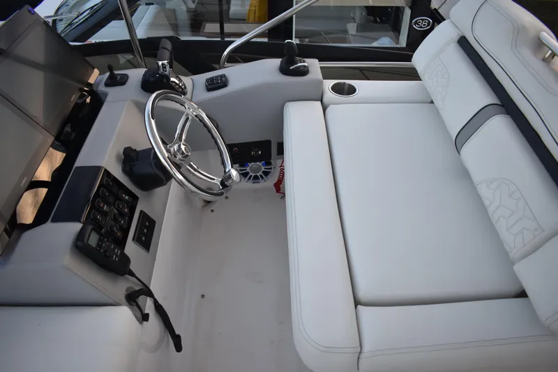 Yacht Photos Pics 2025 Regal 38 FXO boat interior with steering wheel and white seating.