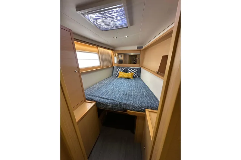 Callisto Yacht Photos Pics Cozy cabin interior of 2014 Lagoon 450 F yacht with bed and window.