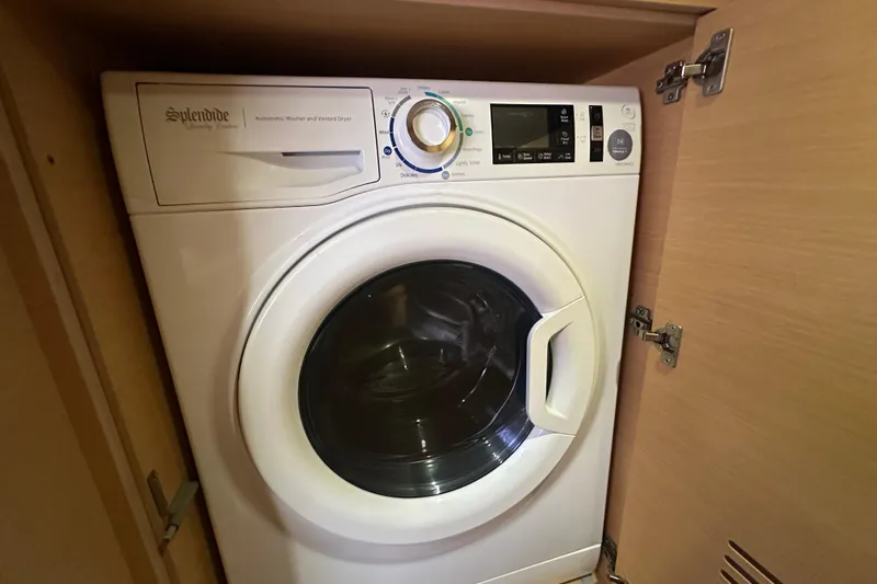 Callisto Yacht Photos Pics Front-loading washing machine in a wooden cabinet on a 2014 Lagoon 450 F yacht.