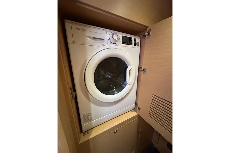 Callisto Yacht Photos Pics Washing machine inside a 2014 Lagoon 450 F yacht's wooden cabinet.