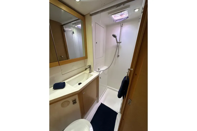 Callisto Yacht Photos Pics Bathroom interior of 2014 Lagoon 450 F yacht, featuring shower and sink.