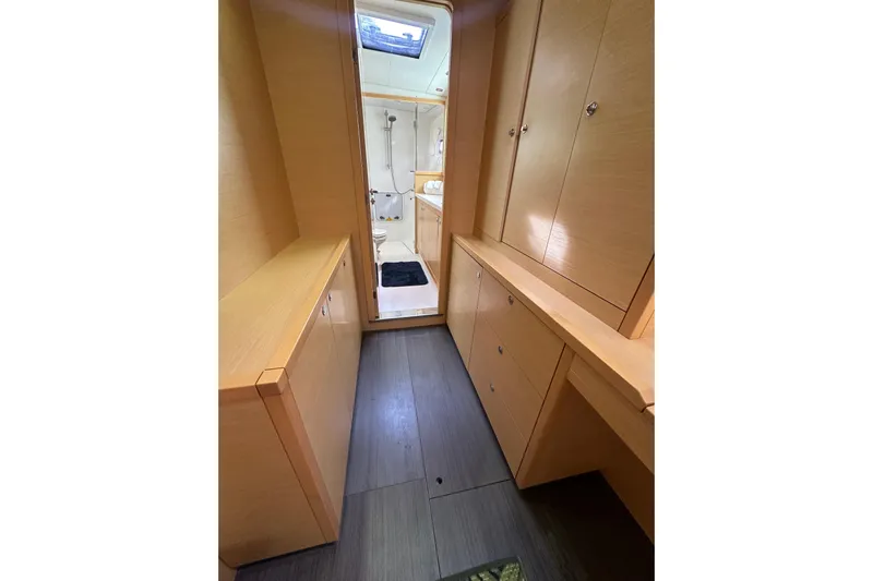 Callisto Yacht Photos Pics Interior of 2014 Lagoon 450 F yacht, featuring wooden cabinetry and a view into the bathroom.