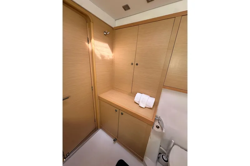 Callisto Yacht Photos Pics 2014 Lagoon 450 F yacht bathroom with wooden cabinets and modern fixtures.
