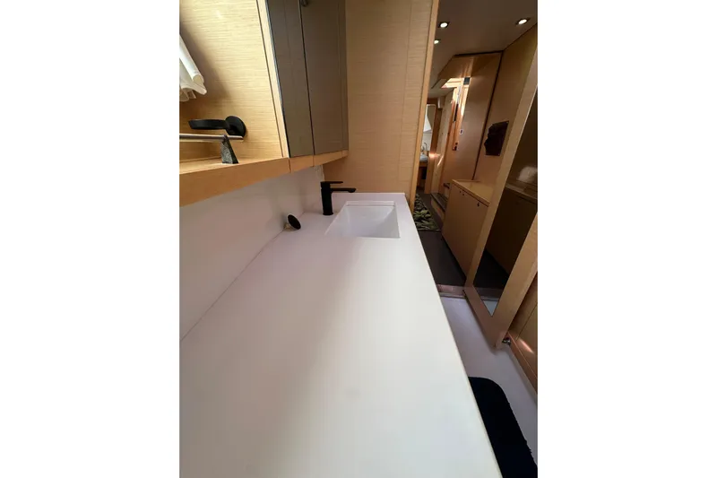 Callisto Yacht Photos Pics Bathroom interior of 2014 Lagoon 450 F yacht, featuring modern sink and cabinetry.
