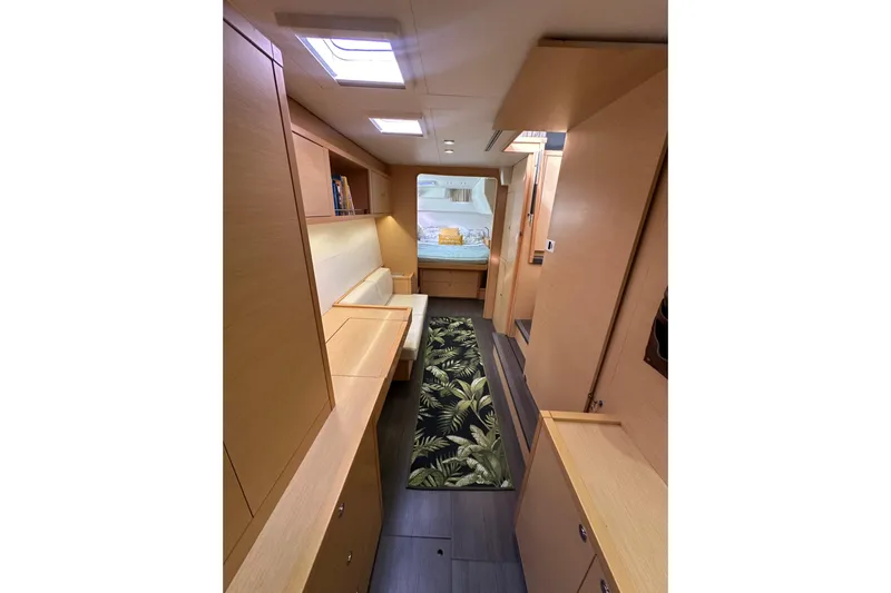 Callisto Yacht Photos Pics Interior of 2014 Lagoon 450 F yacht with modern wood finish and tropical rug.
