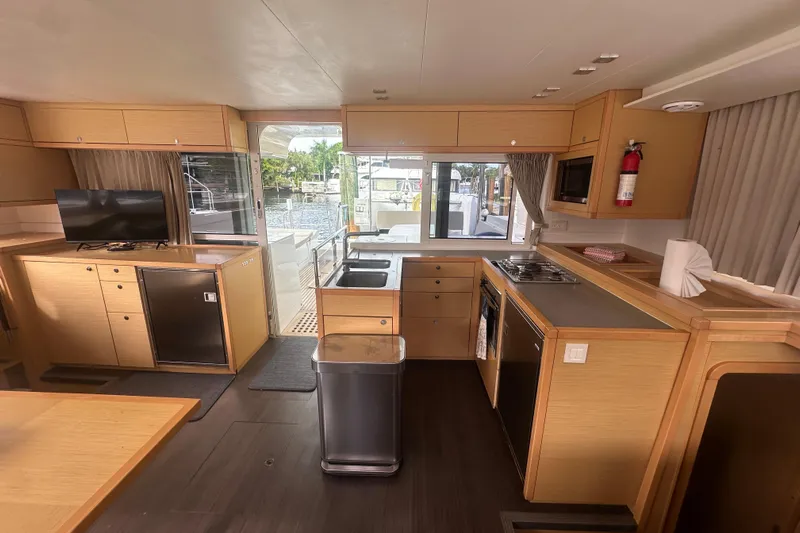 Callisto Yacht Photos Pics Interior of 2014 Lagoon 450 F catamaran with modern kitchen and living area.