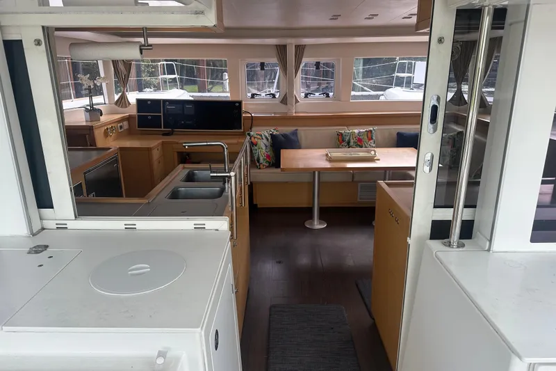 Callisto Yacht Photos Pics Interior of 2014 Lagoon 450 F catamaran, featuring modern kitchen and cozy dining area.