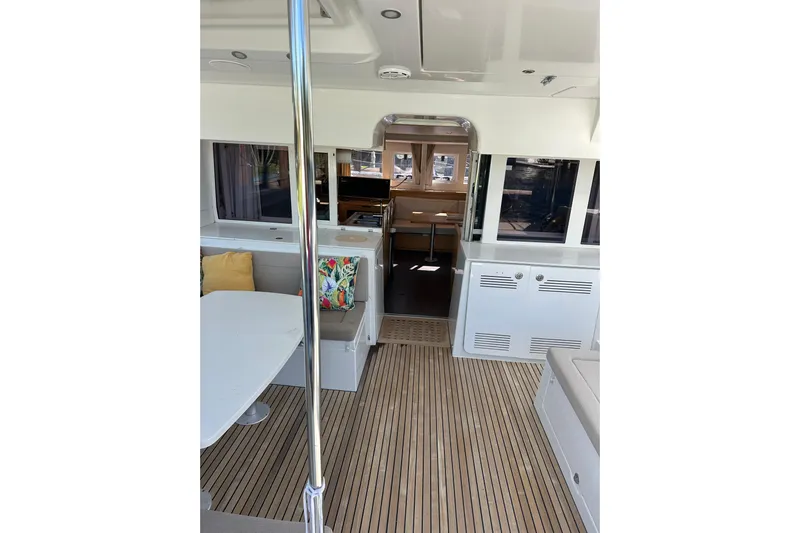 Callisto Yacht Photos Pics Interior of 2014 Lagoon 450 F catamaran with modern seating and wooden flooring.
