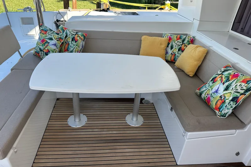 Callisto Yacht Photos Pics Outdoor seating area on 2014 Lagoon 450 F yacht with colorful cushions and table.
