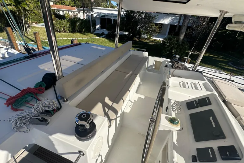 Callisto Yacht Photos Pics 2014 Lagoon 450 F yacht cockpit with seating, ropes, and navigation equipment.