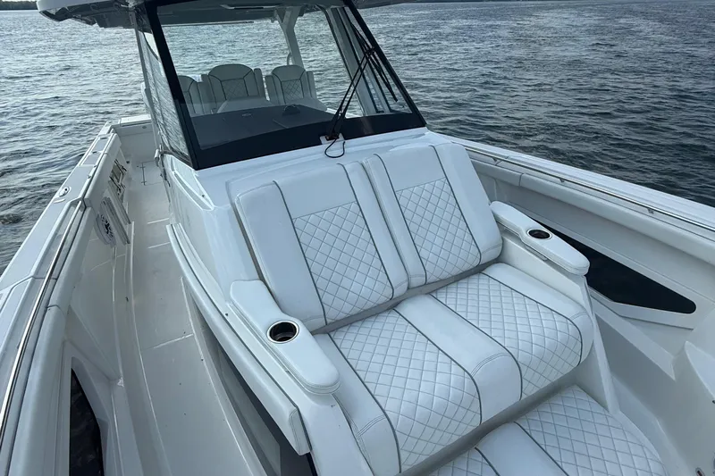 Oorah Yacht Photos Pics 2022 Pursuit S 378 Sport boat with luxurious seating on calm water.