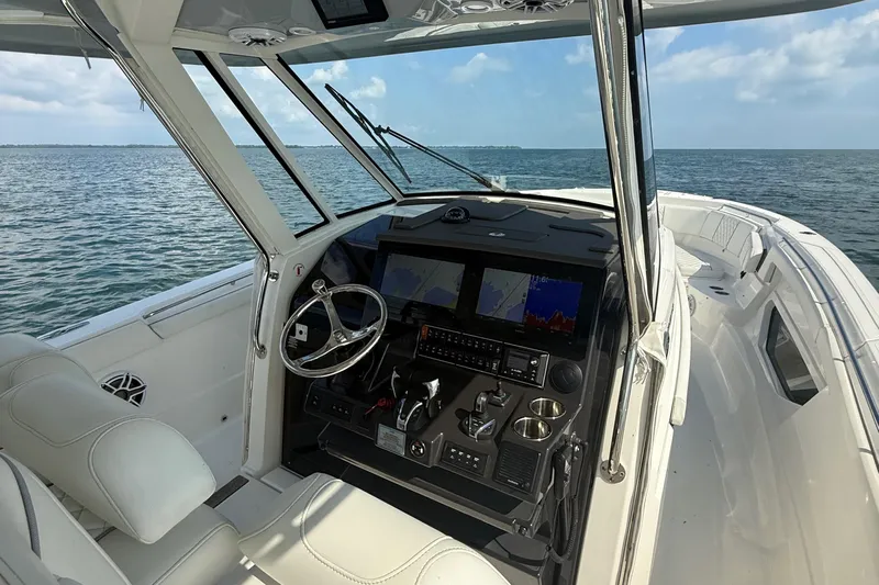 Oorah Yacht Photos Pics 2022 Pursuit S 378 Sport boat interior with advanced navigation system on open water.