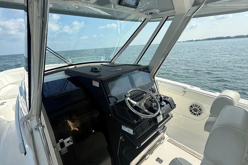 Oorah Yacht Photos Pics 2022 Pursuit S 378 Sport boat helm with ocean view and modern controls.