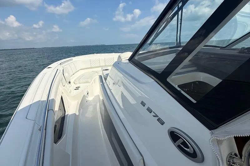 Oorah Yacht Photos Pics 2022 Pursuit S 378 Sport boat cruising on open water under a clear sky.